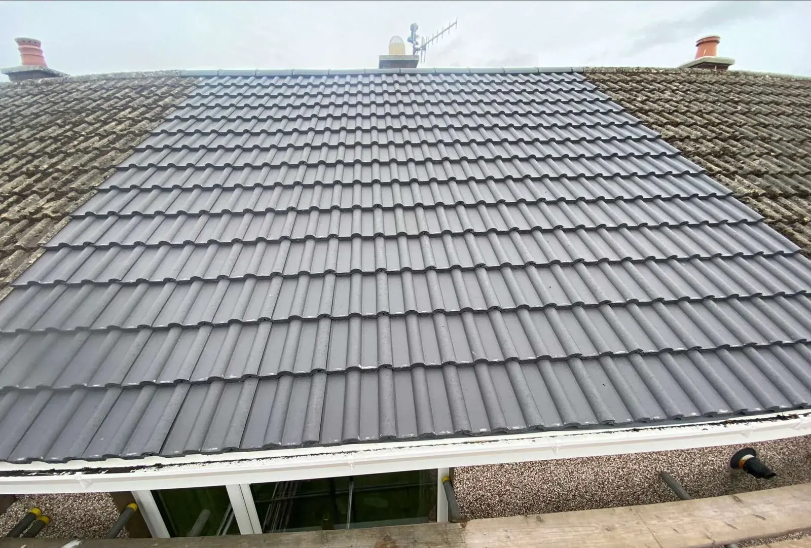 Completed grey concrete tile re-roof by DJW Roofing & Leadwork