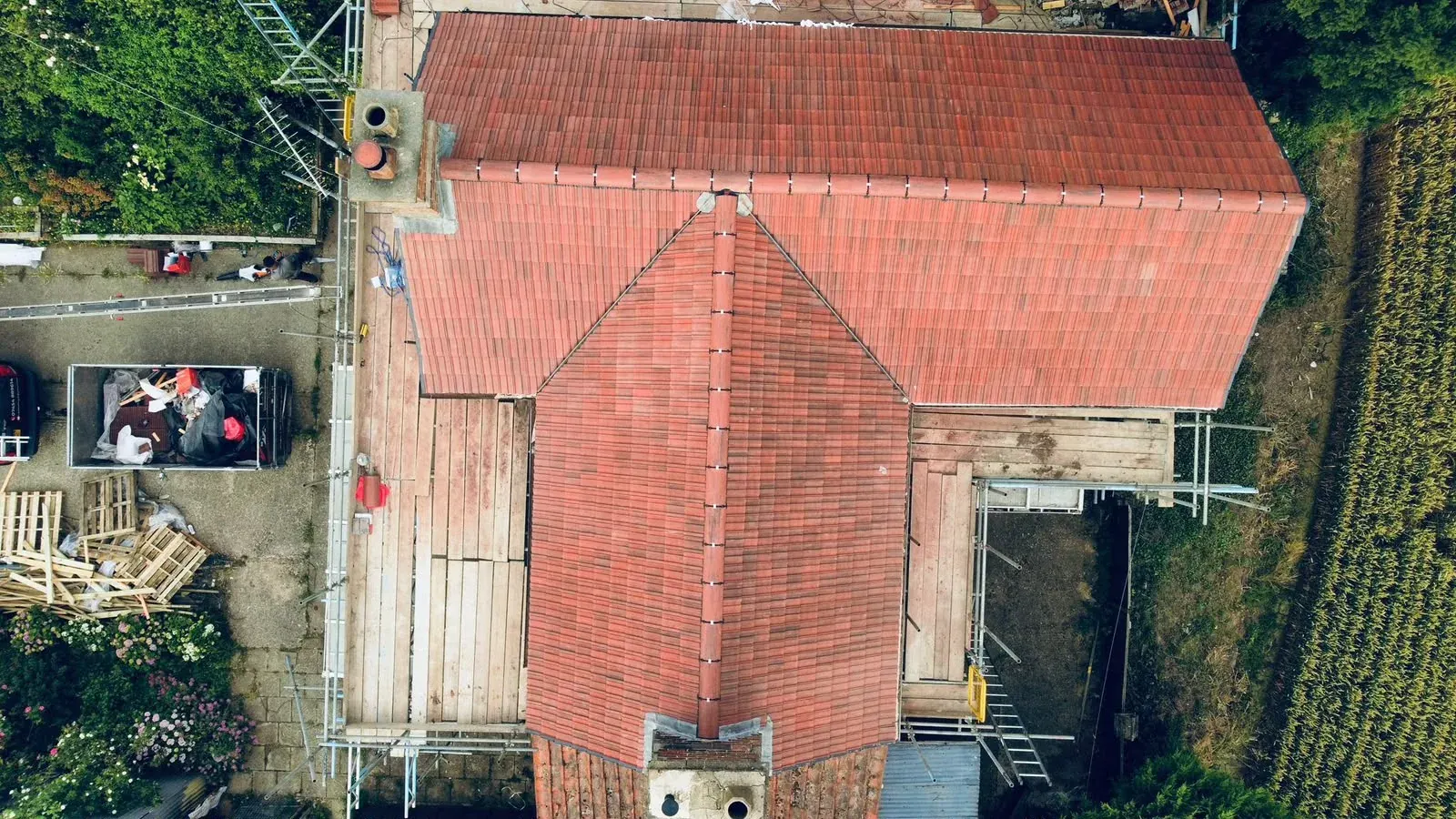Drone view of a clay tile re-roof with scaffolding by DJW Roofing & Leadwork