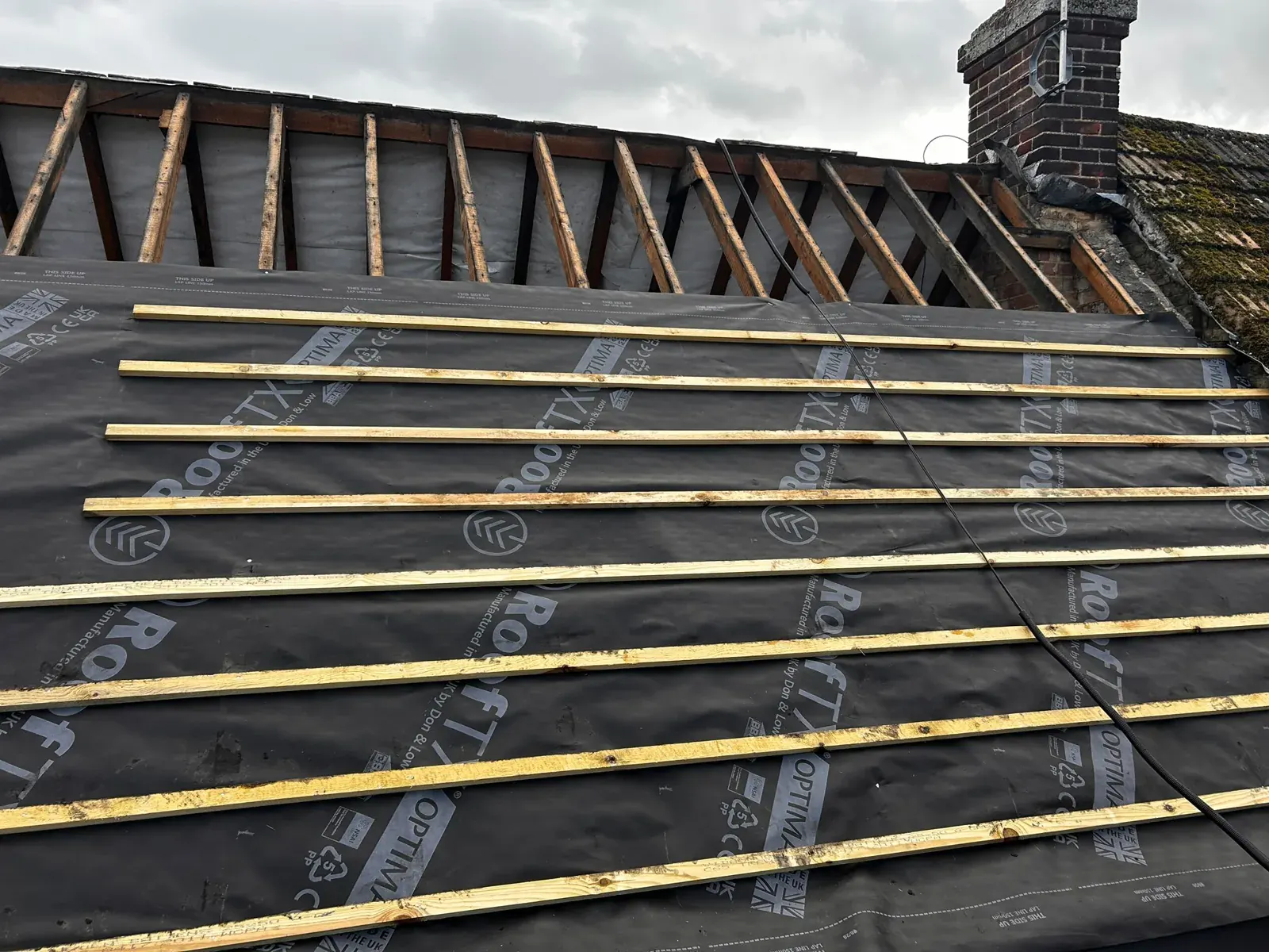 Re-roof stripped back with new membrane and battens around a chimney by DJW Roofing & Leadwork