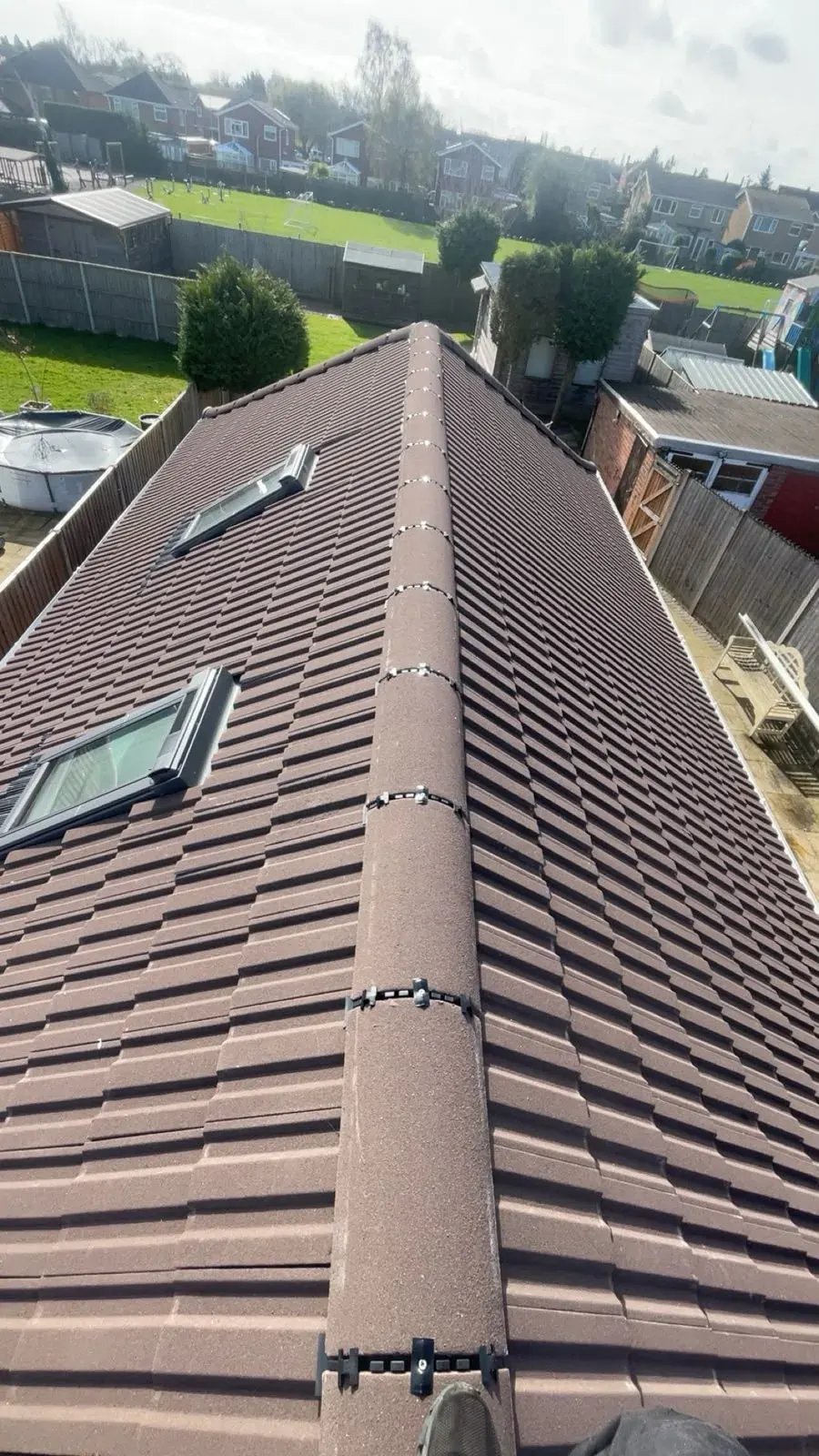 Brown tile roof with dry ridge and roof windows by DJW Roofing & Leadwork